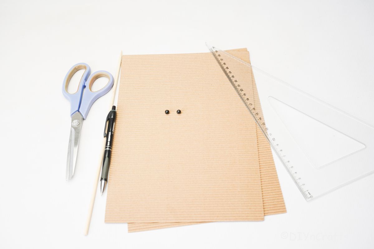 cardboard scissors and marker on white table