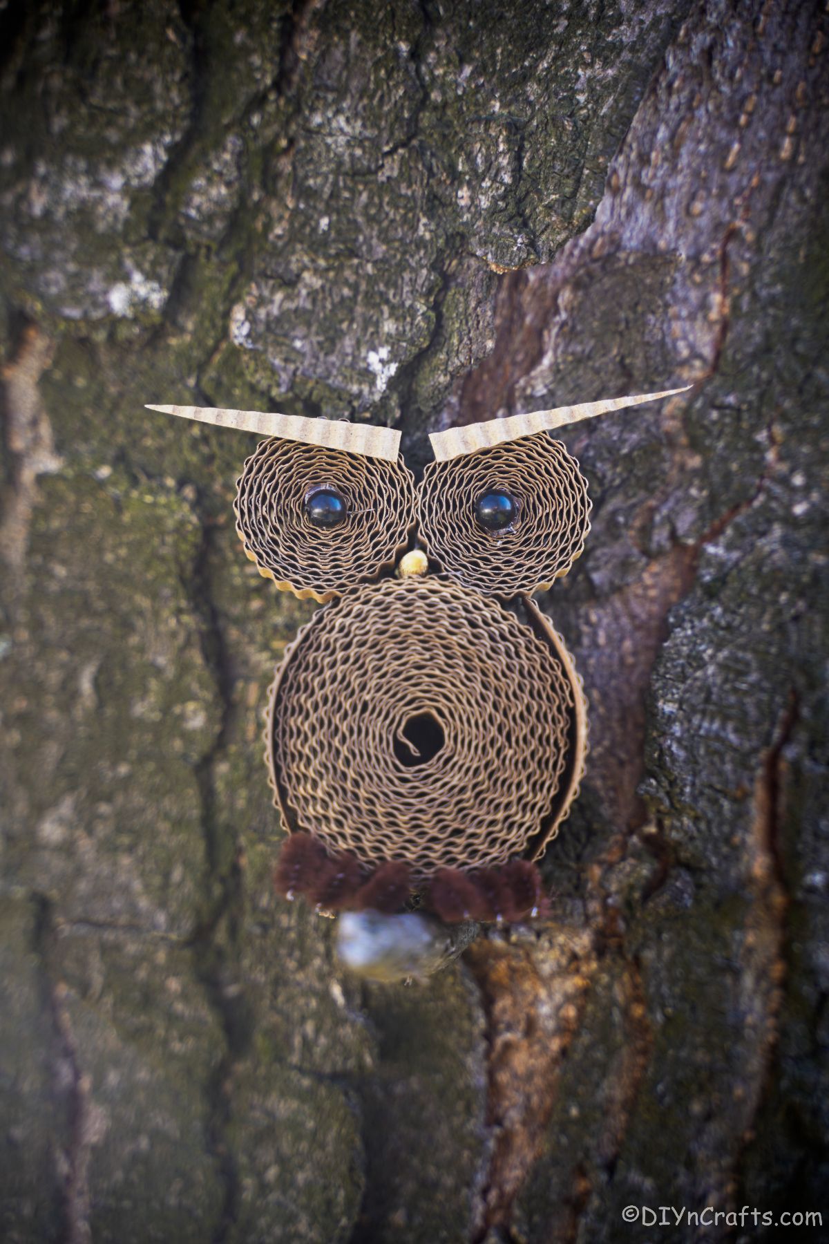 cardboard owl on tree