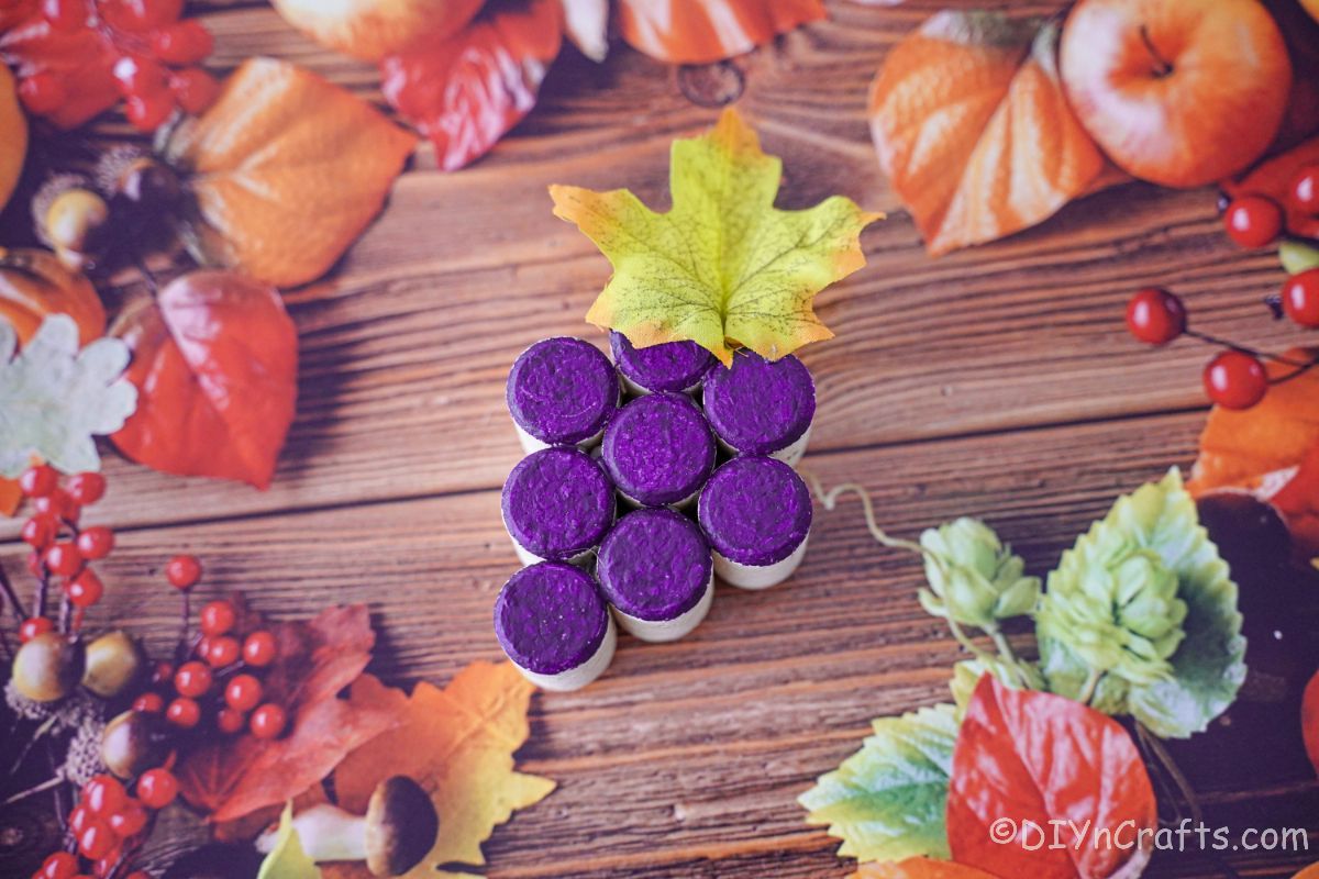 fall leaves scrapbook paper with painted cork grape cluster on top