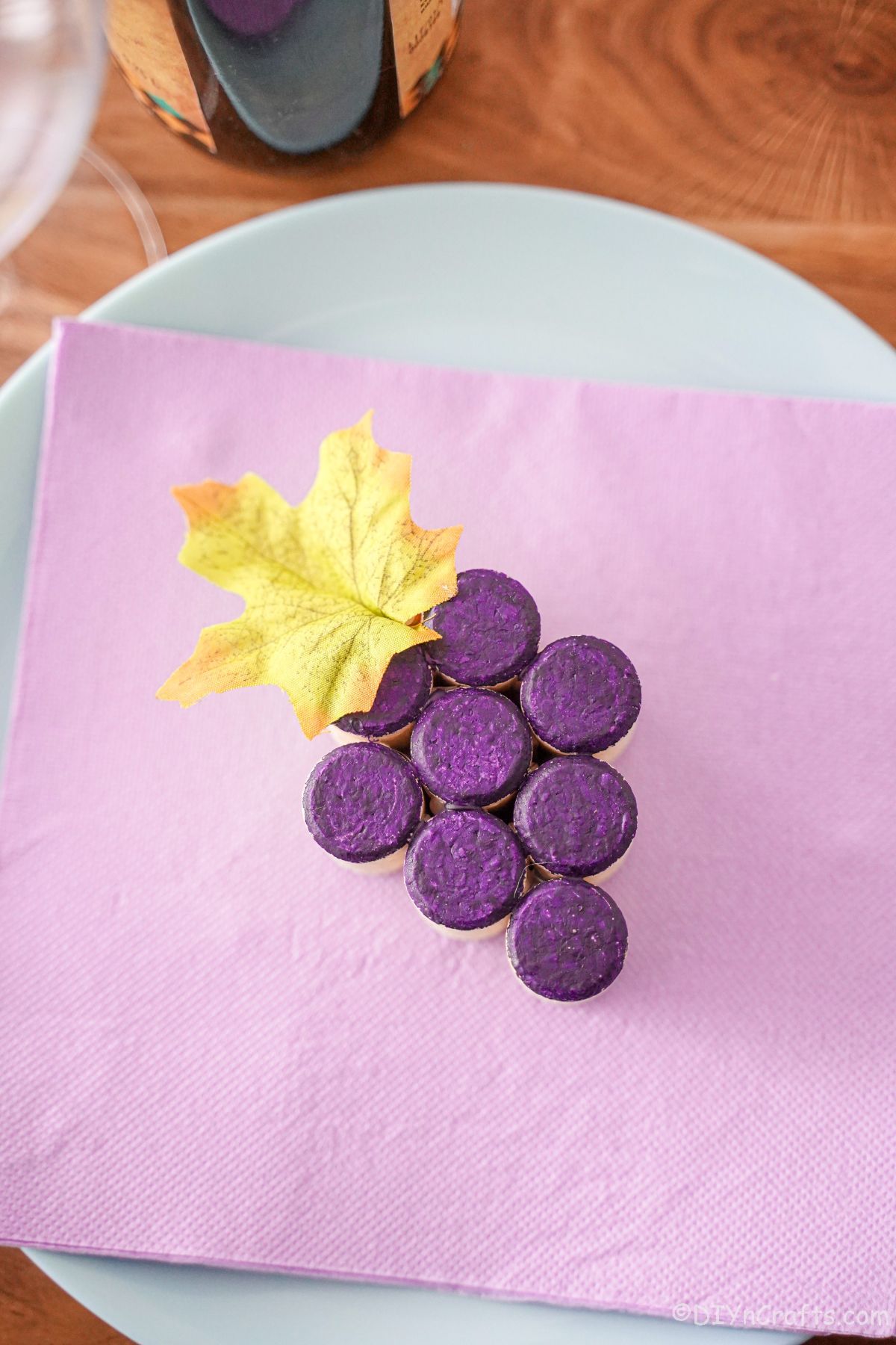 painted wine cork grape cluster sitting on plate