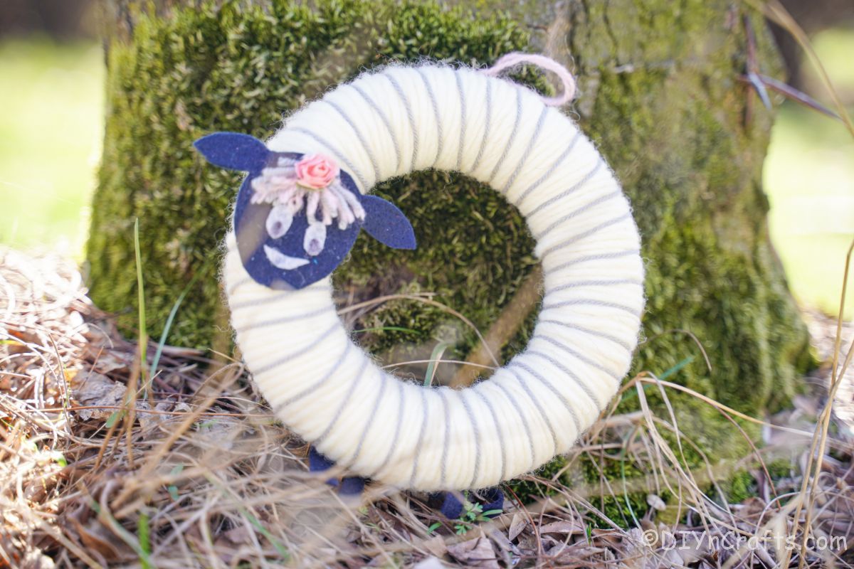 sheep wreath against tree trunk