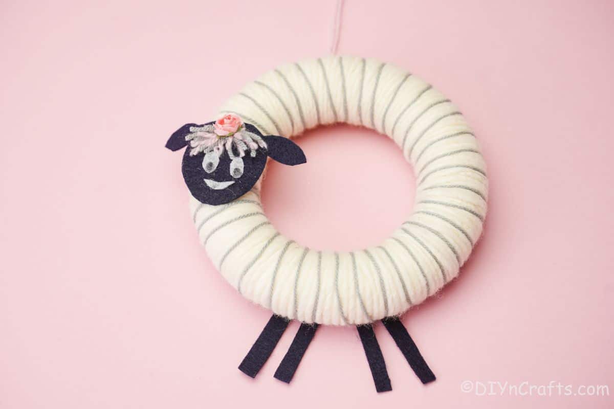 white sheep wreath on pink background