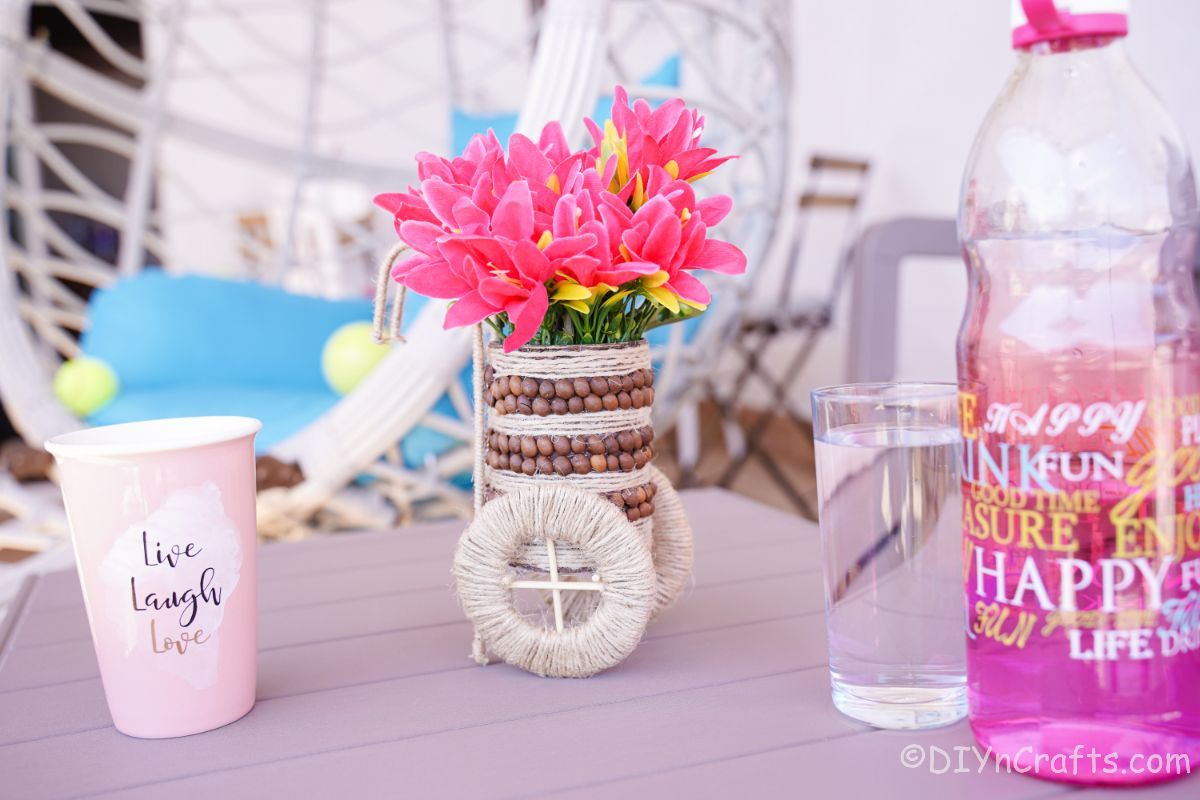 tin can vase on table with pink flowers