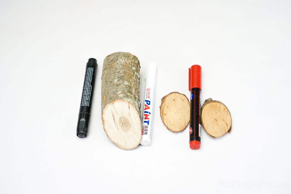 log wood slices and markers on white table