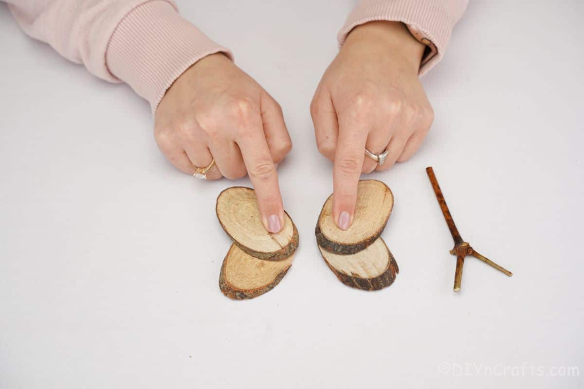 hand holding wood slice on top of each other