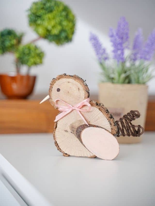 wood slice chicken on table with purple flowers in background