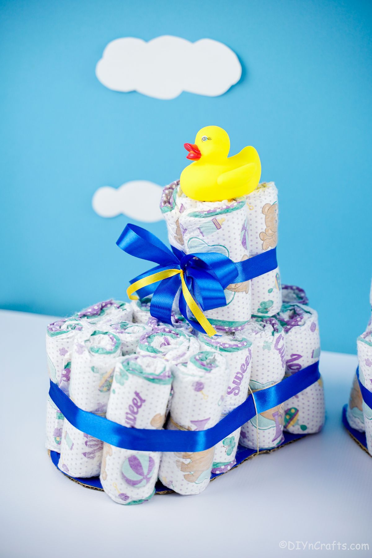 blue wall behind blue accent diaper cake shoe with rubber duck on top