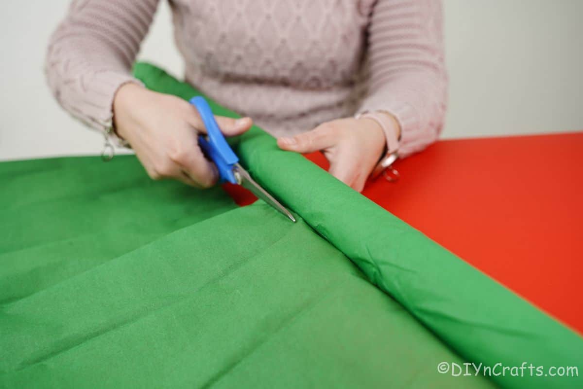 lady cutting green paper