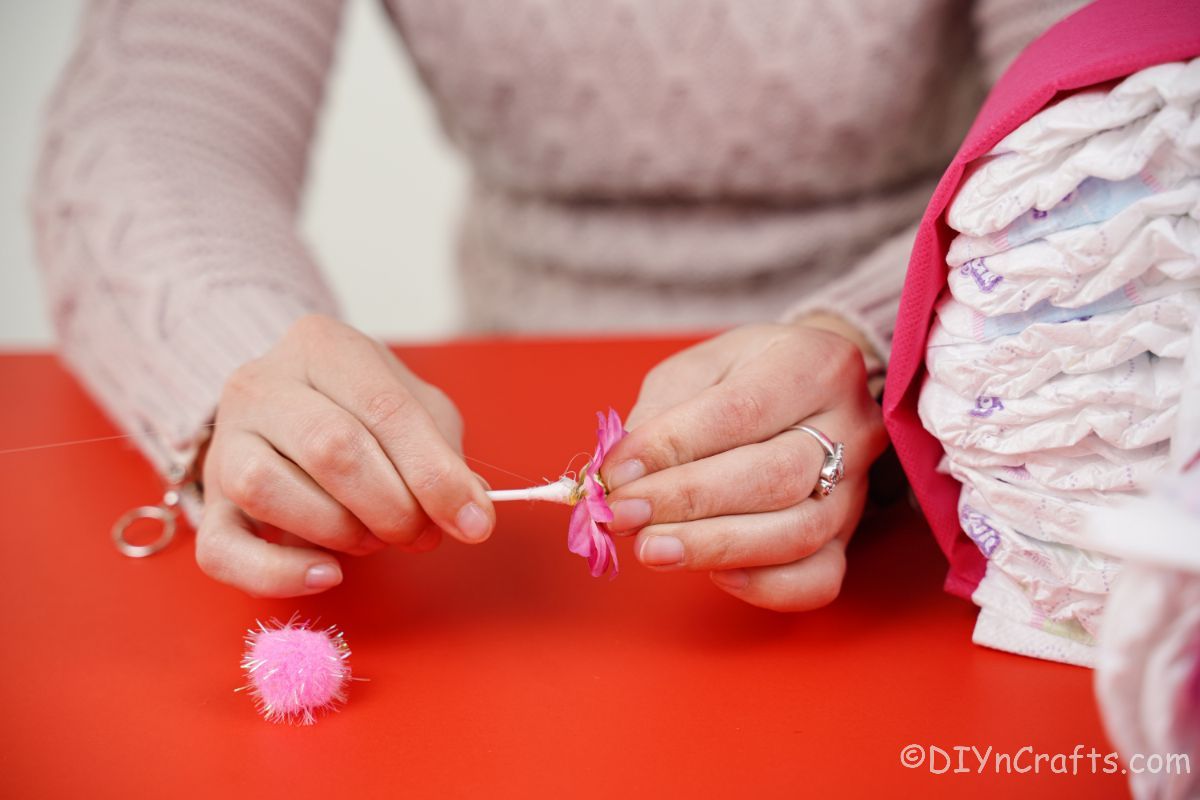 hand gluing q-tip to back of fake flower