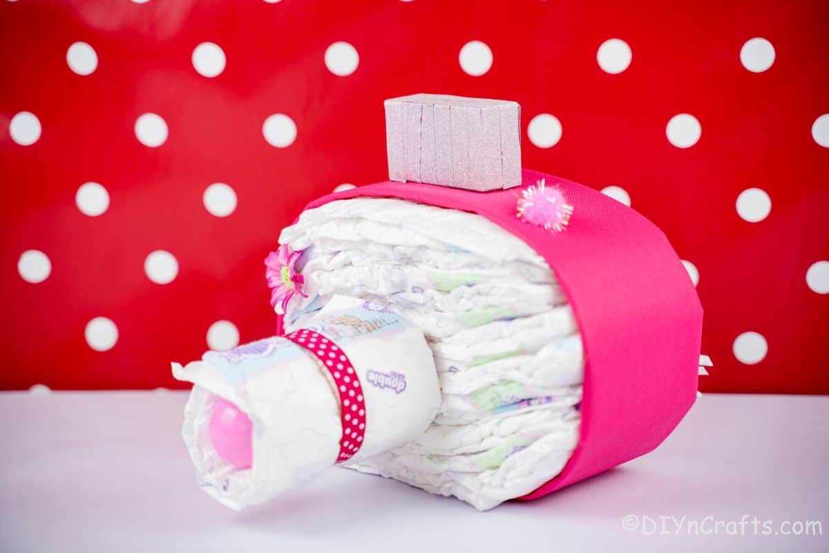 pink diaper cake camera with red and white polka dot background