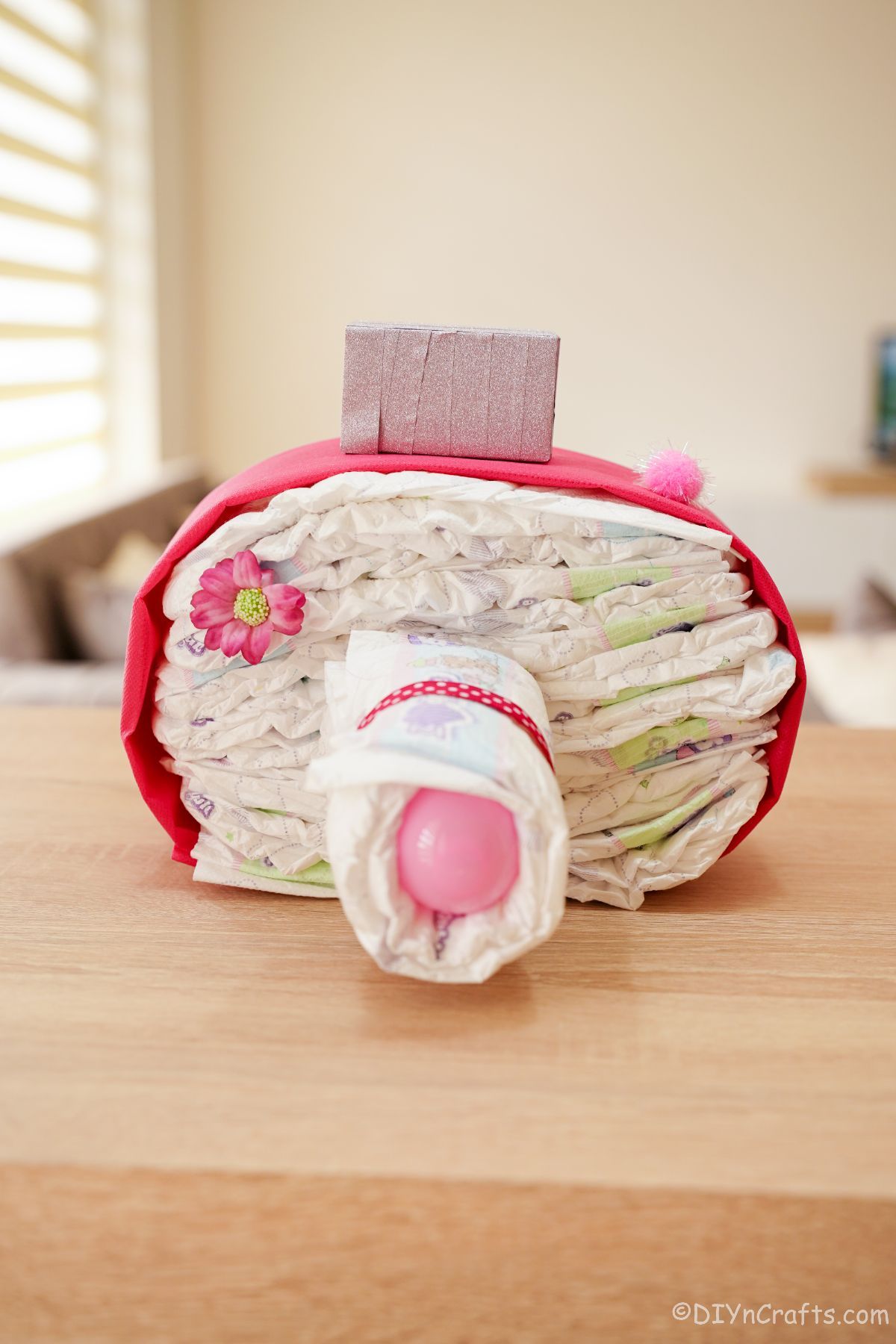 camera diaper cake on wood table
