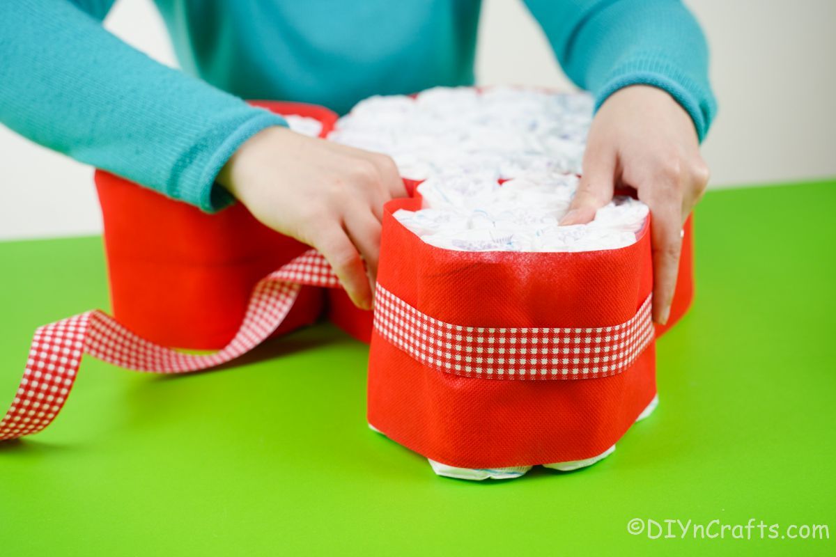 wrapping ribbon around diaper cake