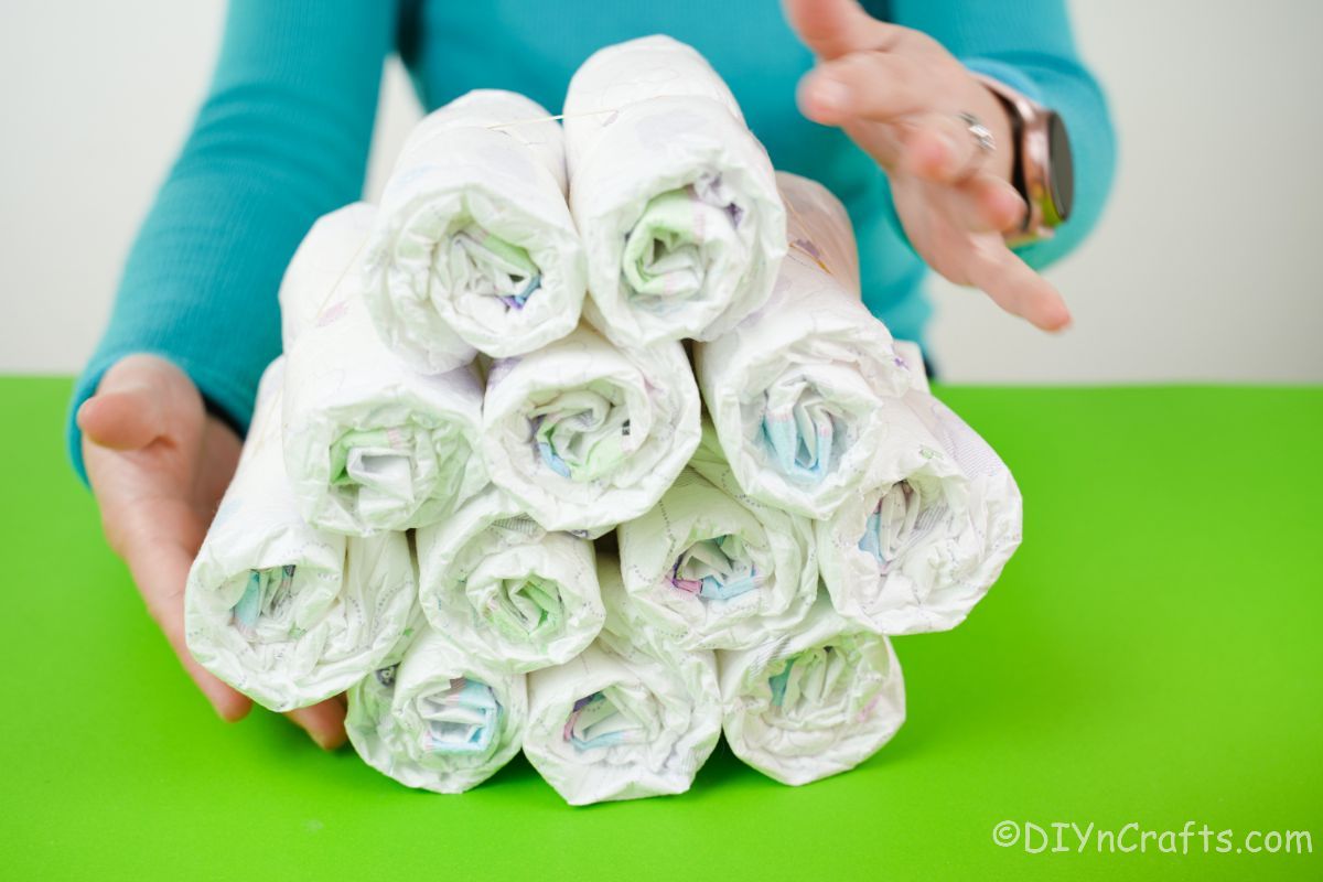 bundle of rolled diapers sitting on green table