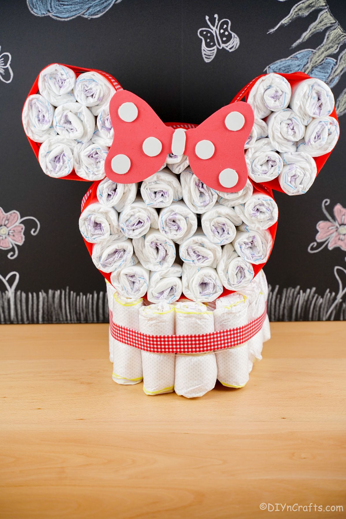 Disney Minnie Mouse head diaper cake on table with chalkboard background