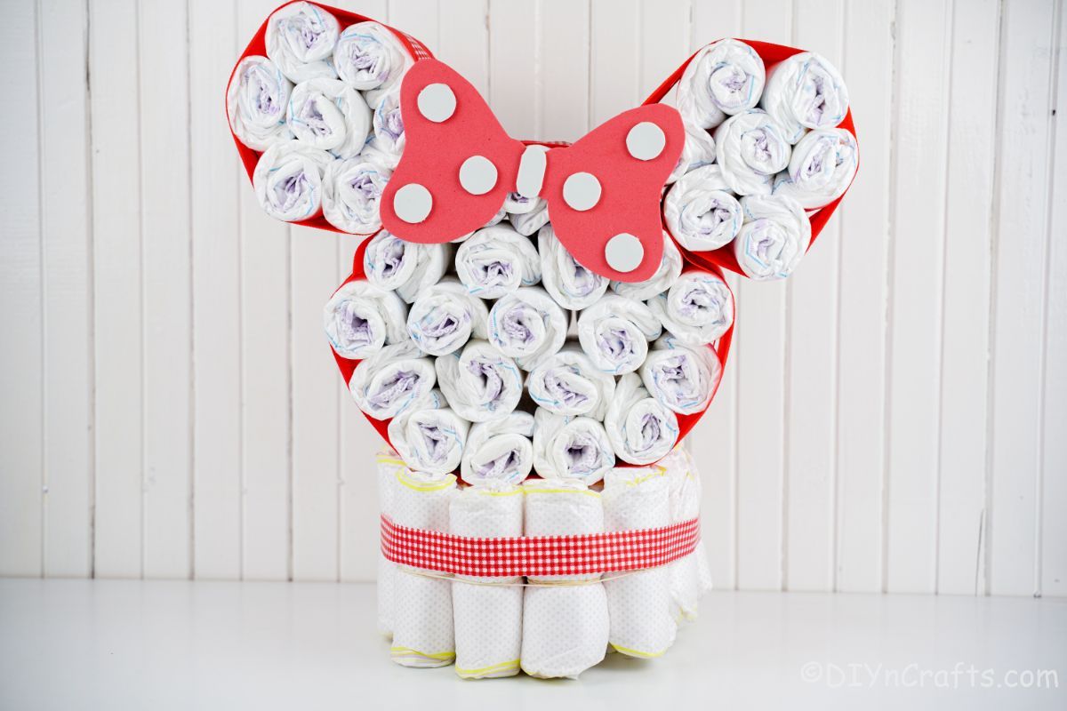 white paneling behind minnie mouse diaper cake
