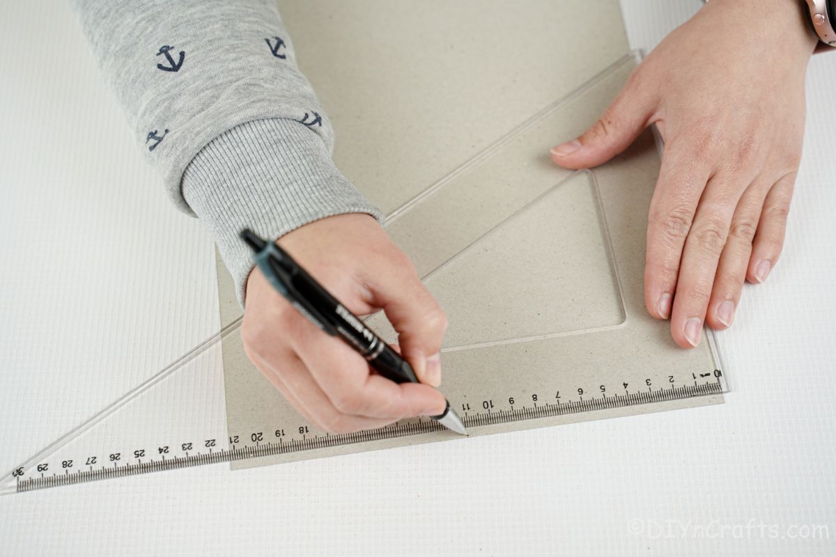 ruler and pen measuring against paper