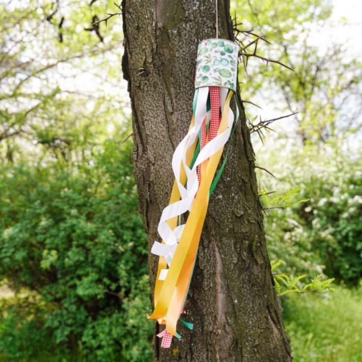 tin can windsock hanging on tree
