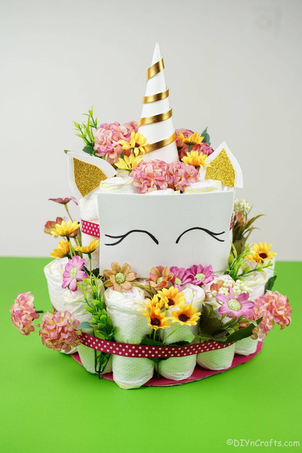 diaper cake unicorn on green table with white background