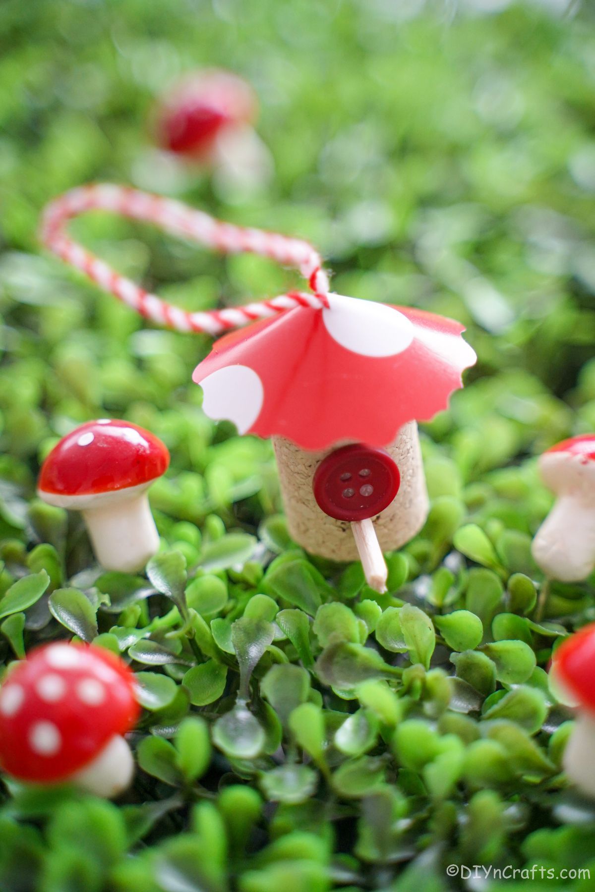 ceramic mini mushrooms and wine cork house with red roof on clover