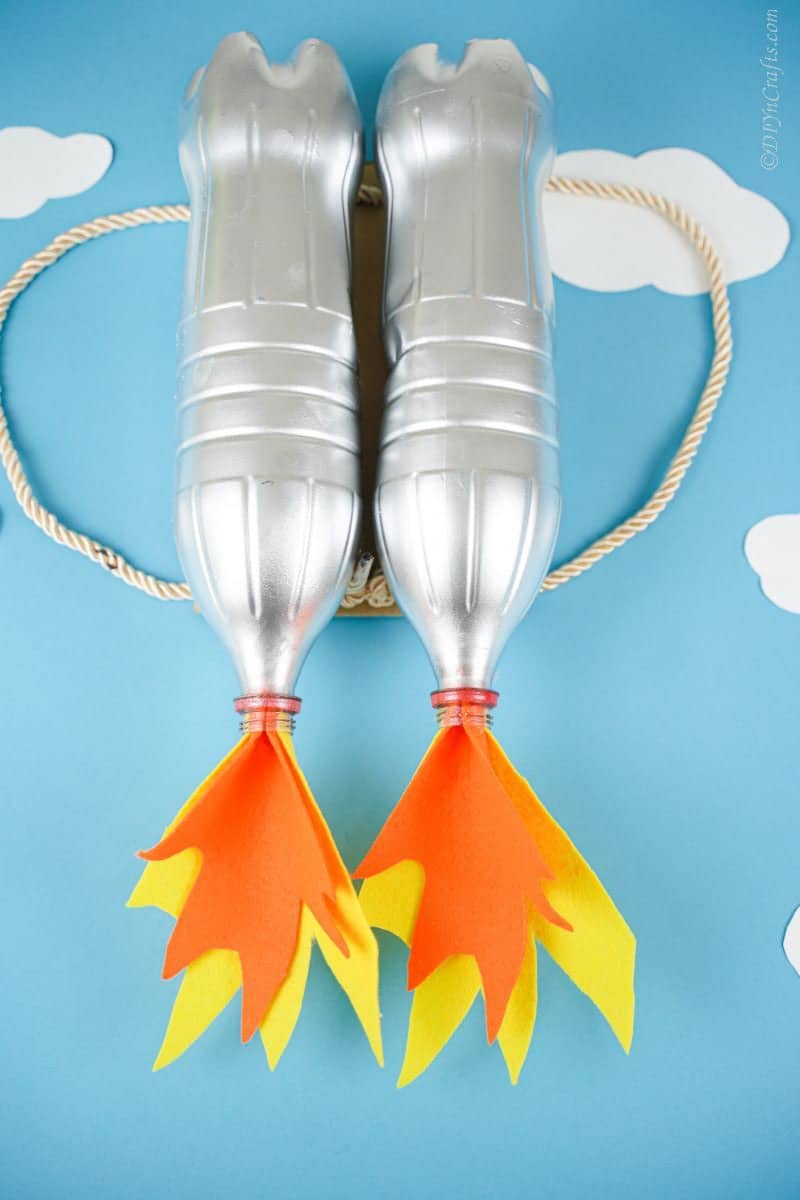 light blue background behind silver bottle jet pack