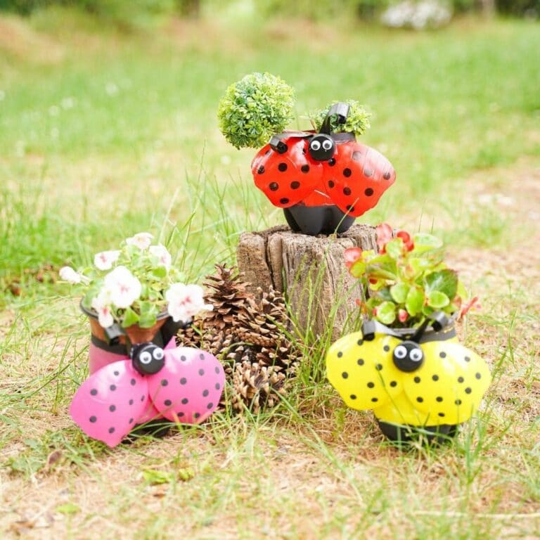 red pink and yellow ladybug planters by stump
