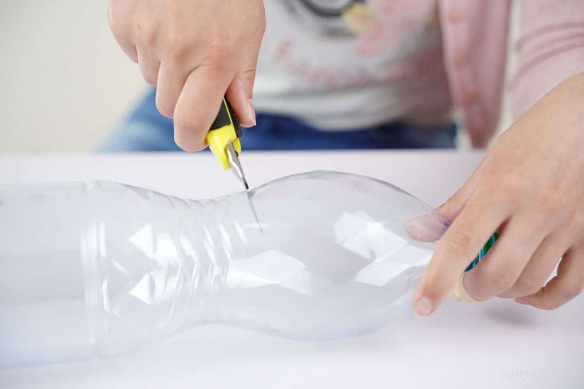 craft knife cutting plastic bottle