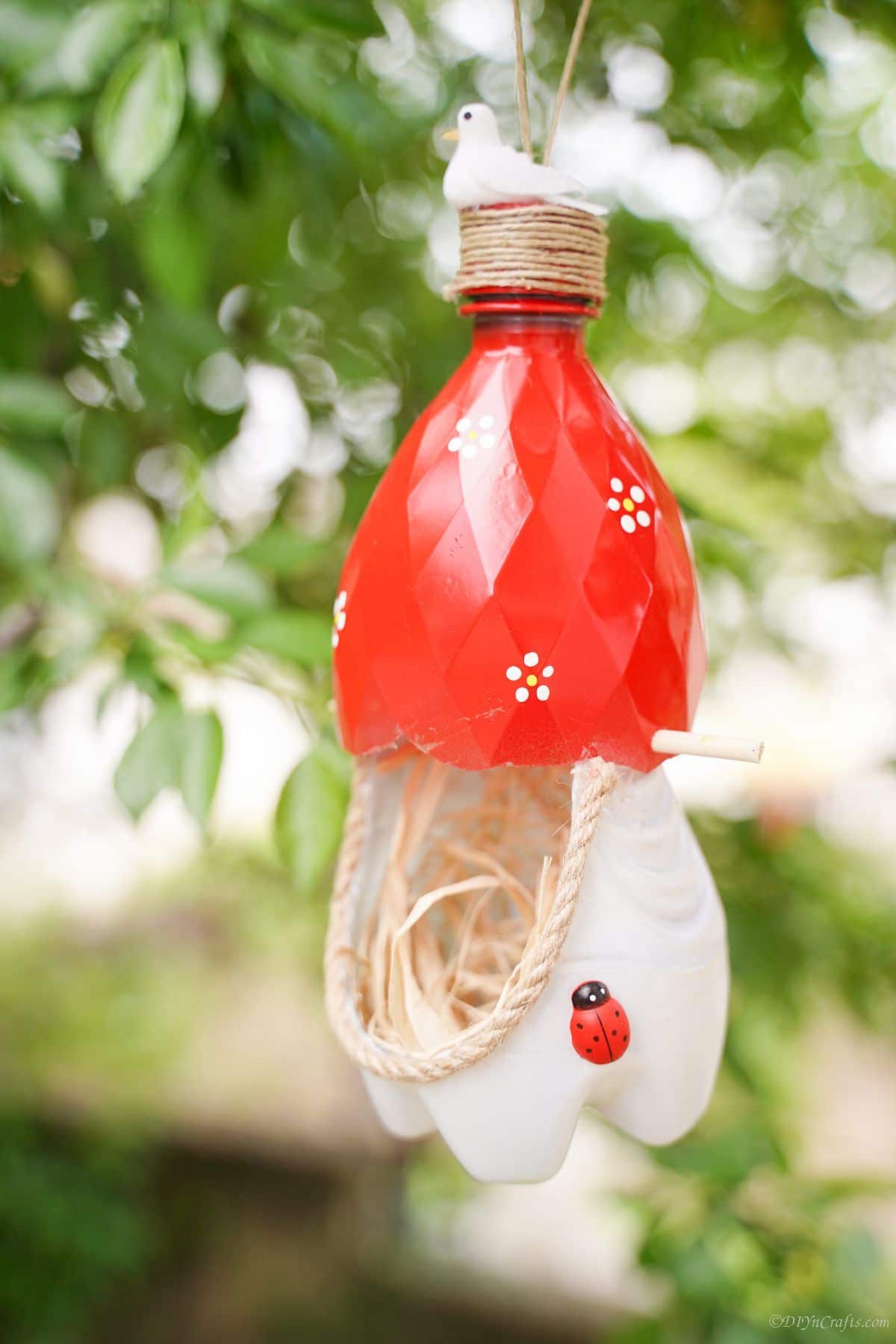 birds nest made of plastic bottles in tree