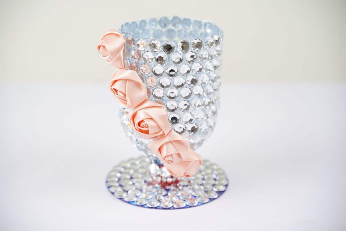 rhinestone vase with pink flowers on white table