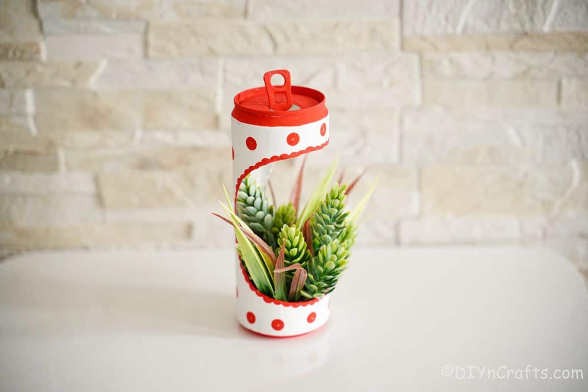 succulent planter made of a coke can on white table