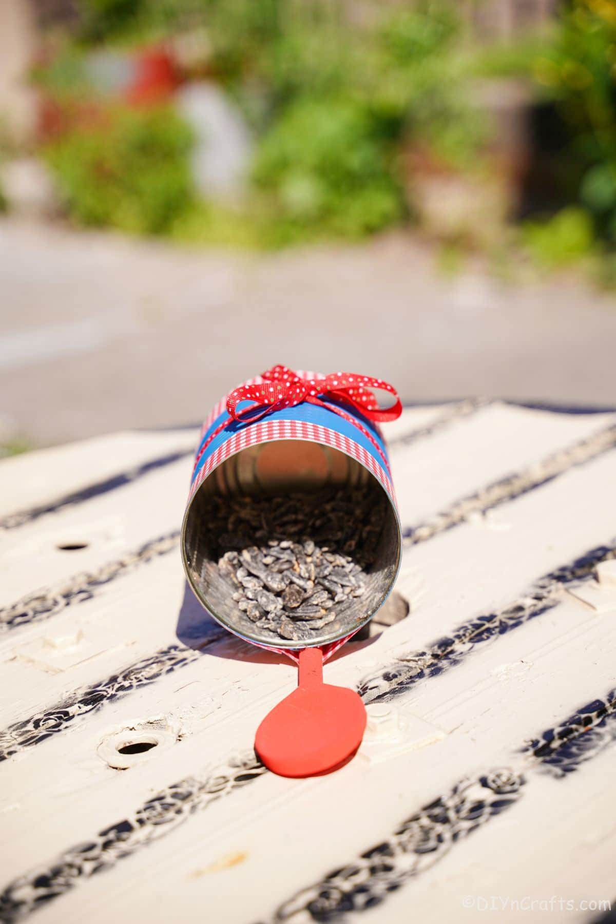 red wood spoon perch on bird feeder on table