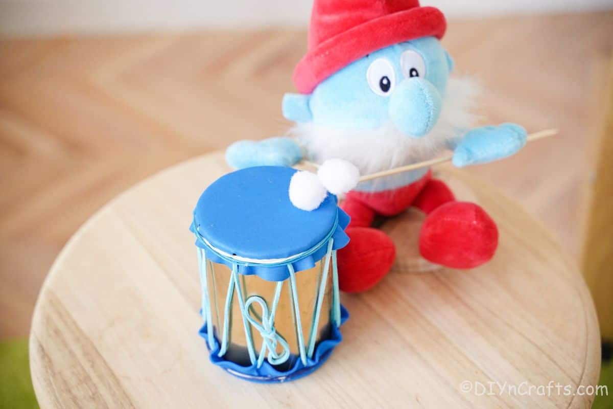 papa smurf on wood stool with blue mini drum