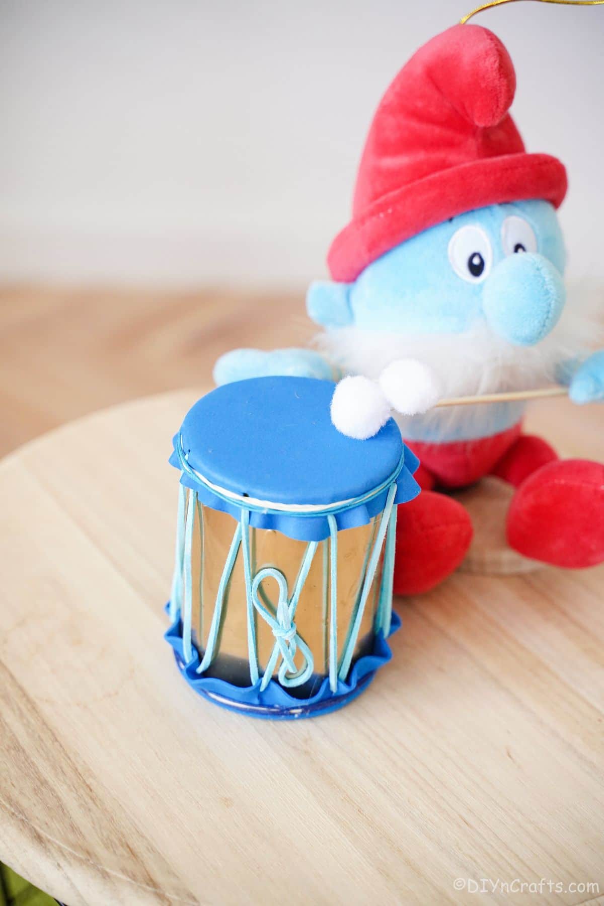 smurf by mini drum on table