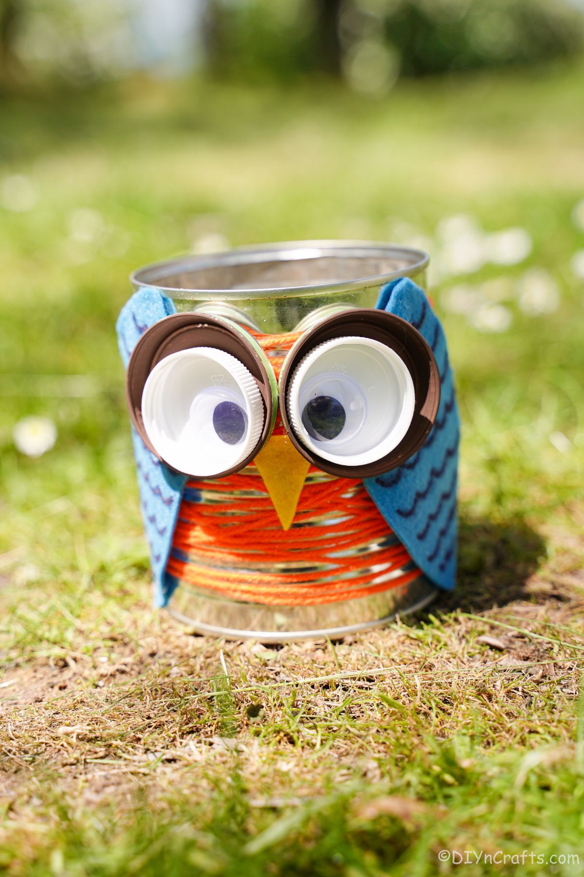 owl made of tin can on grass