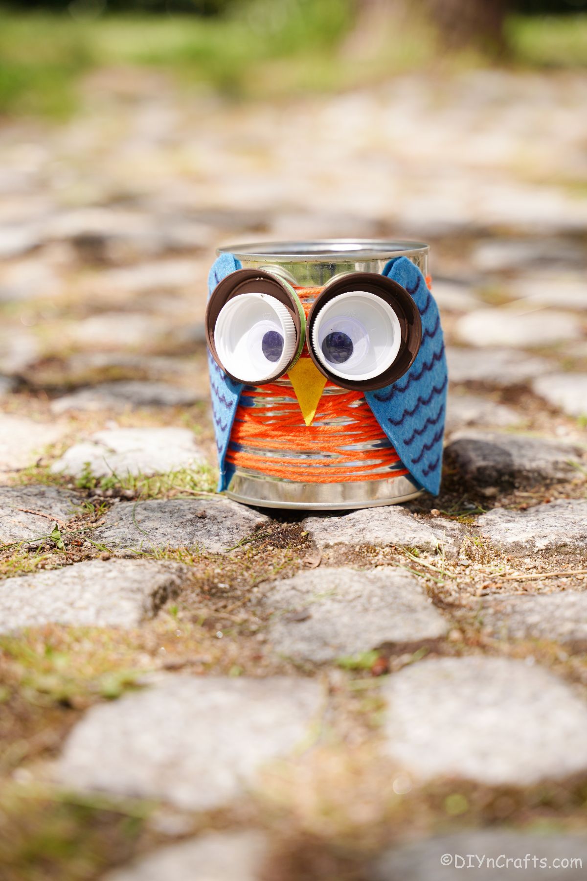 tin can owl on cobblestone