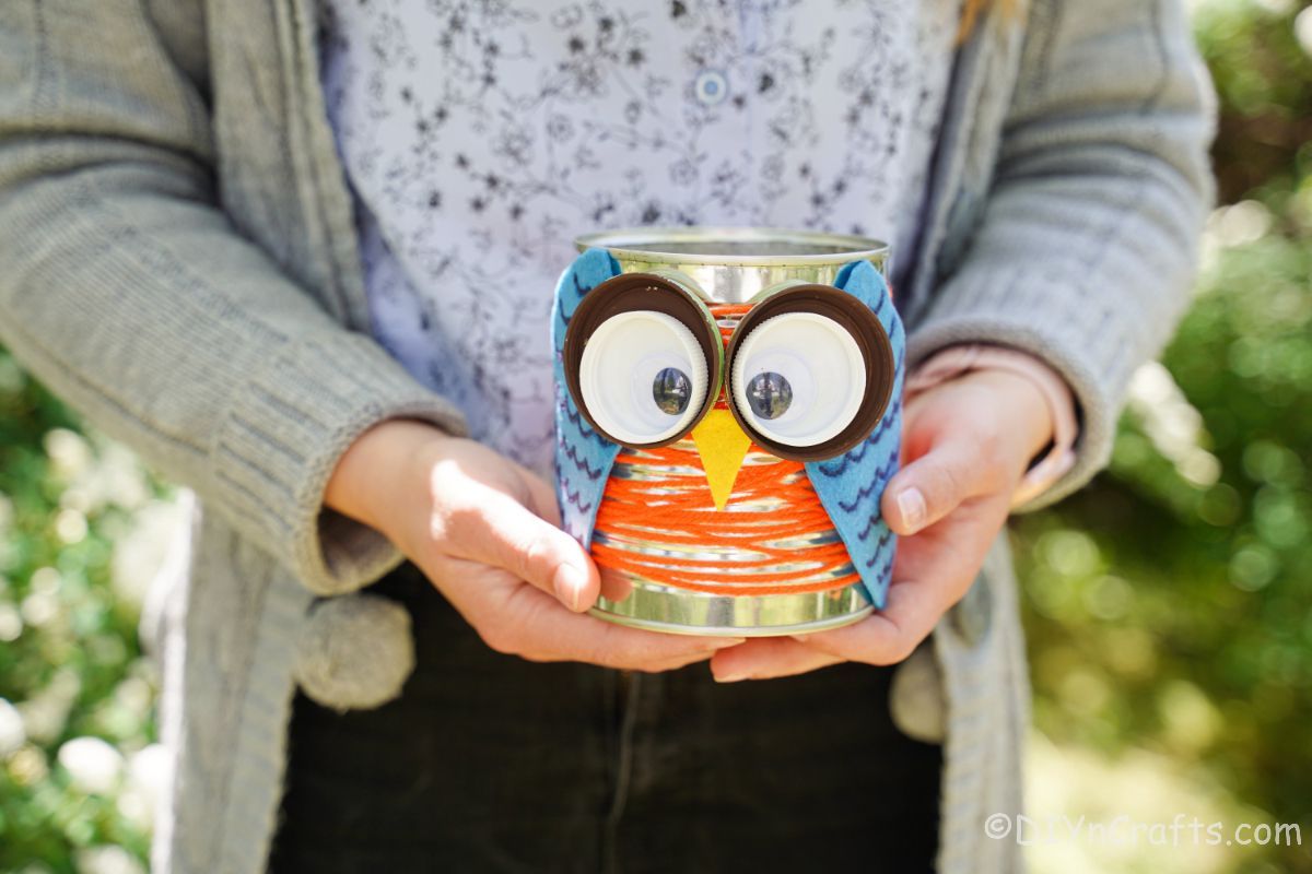 woman holding a can of owl