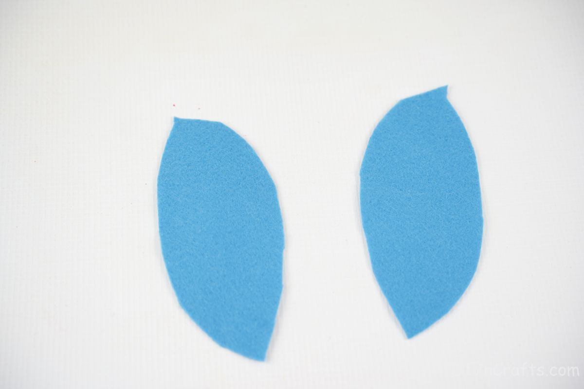 two blue wing shapes on white table