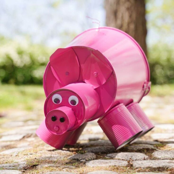 metal pink pig on cobblestone