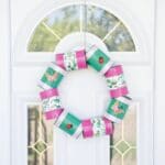 green and pink can wreath on white door with glass panels