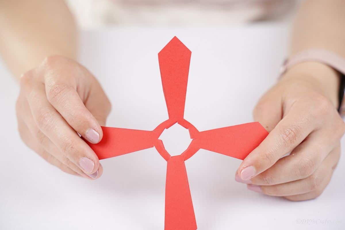 hand holding red paper propeller
