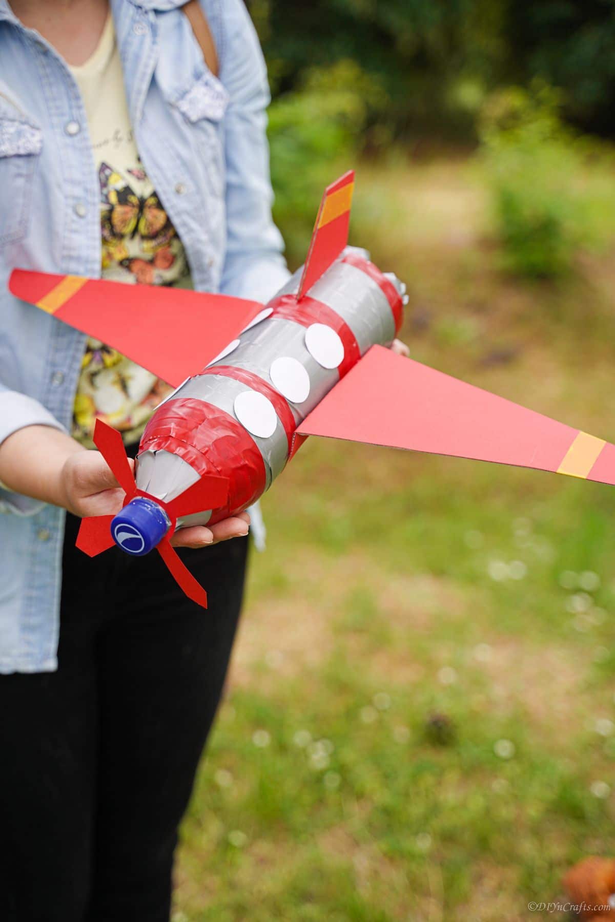 woman holding plastic bottle airplane