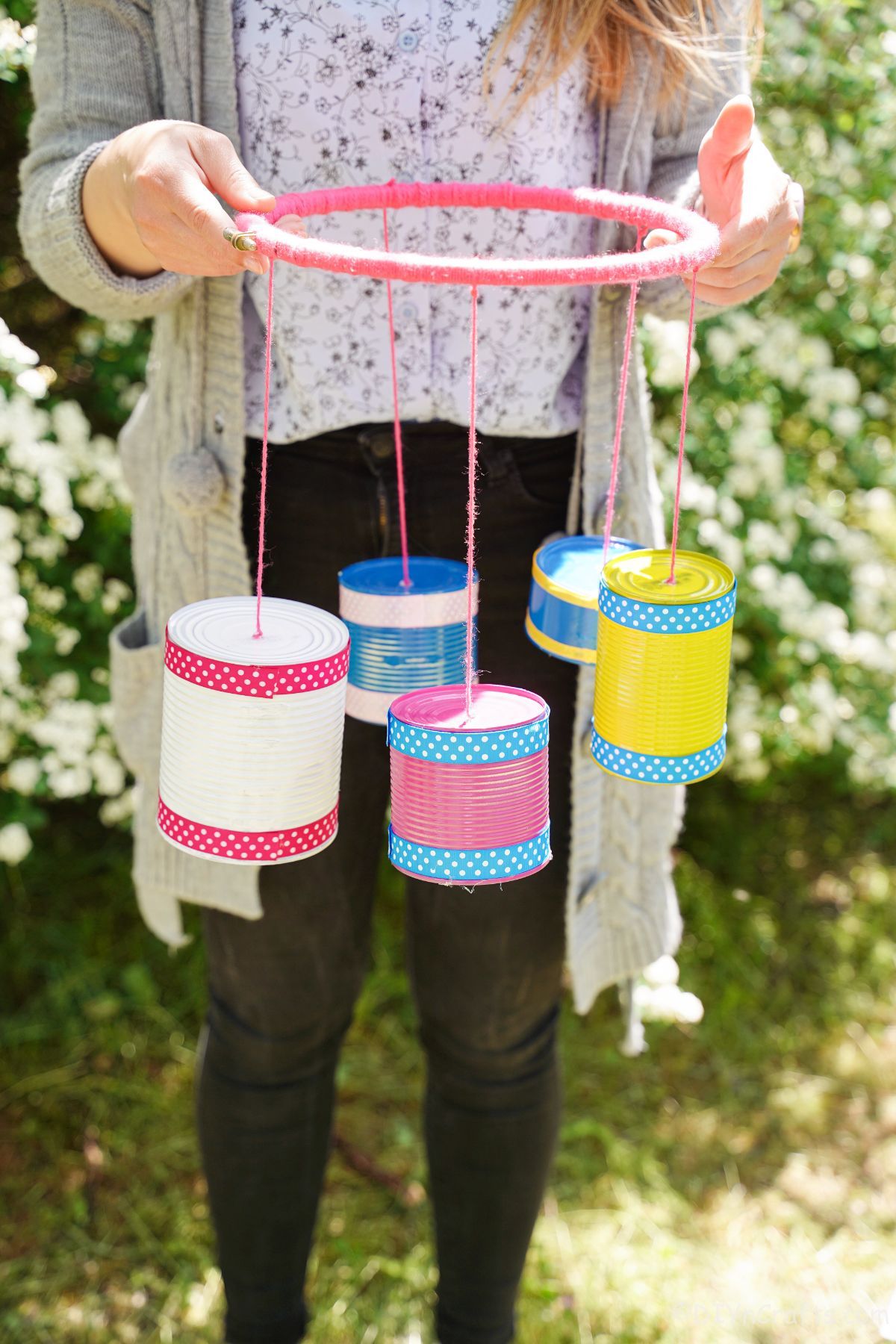 woman holding a colorful windchime