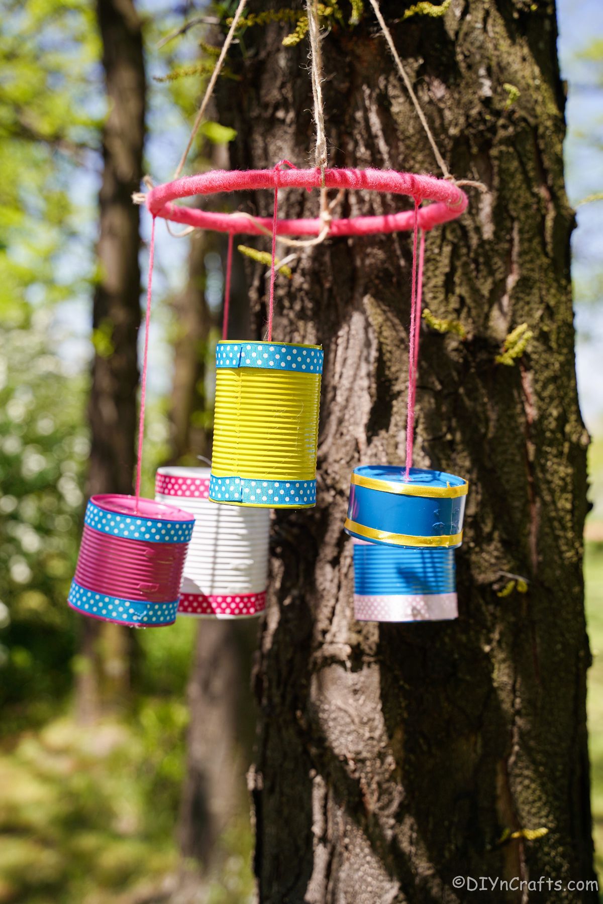 pink blue yellow and white chimes hanging on tree