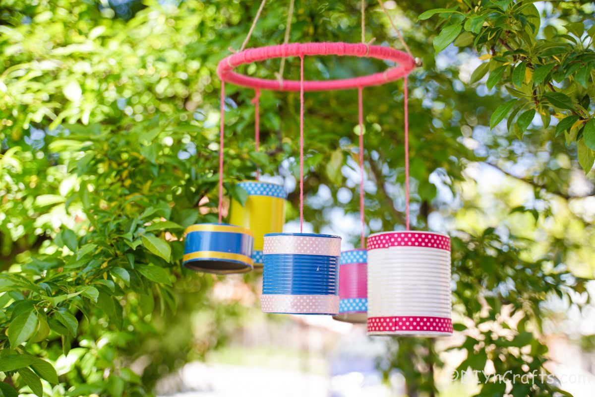 pink base for tin can chime hanging in tree