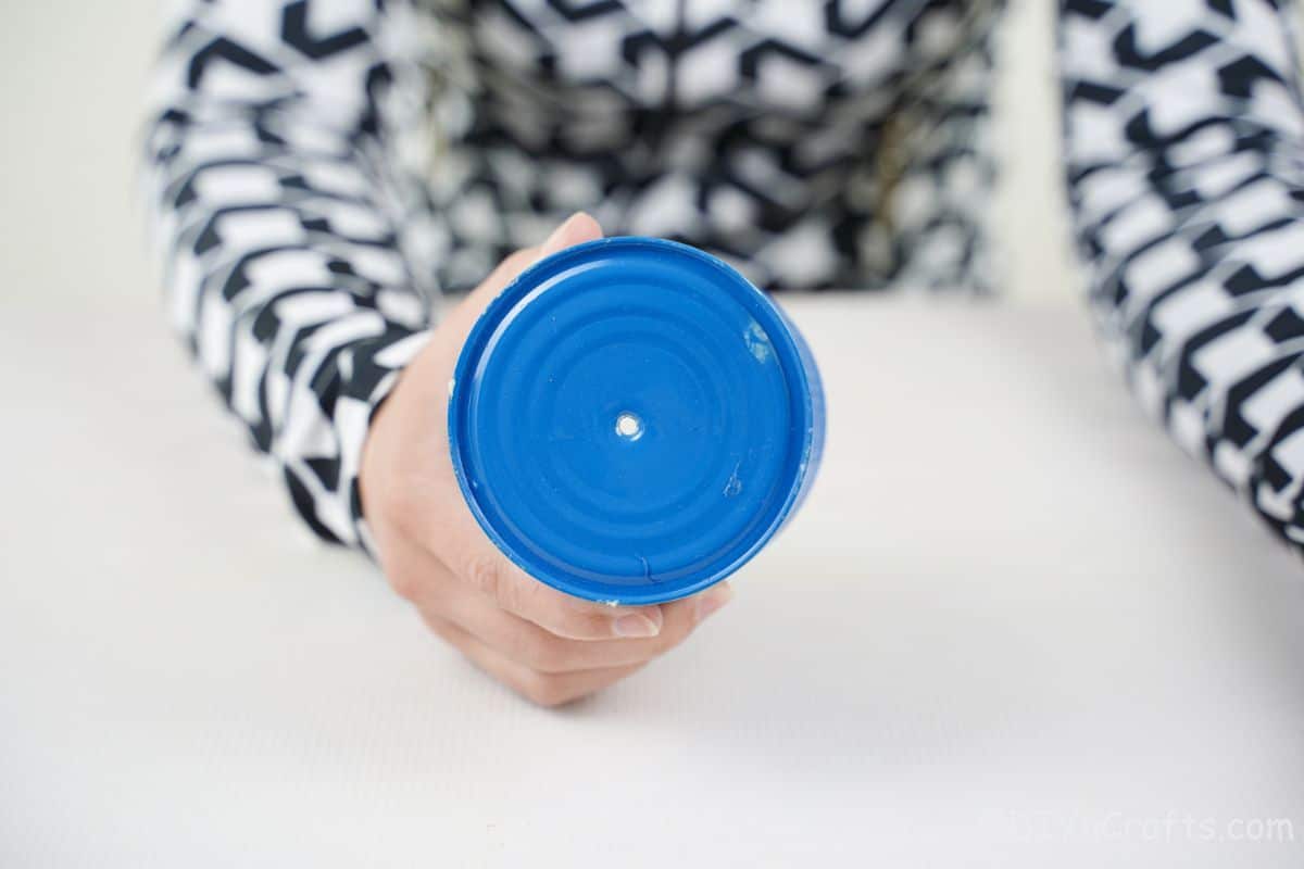 hole in end of blue tin can