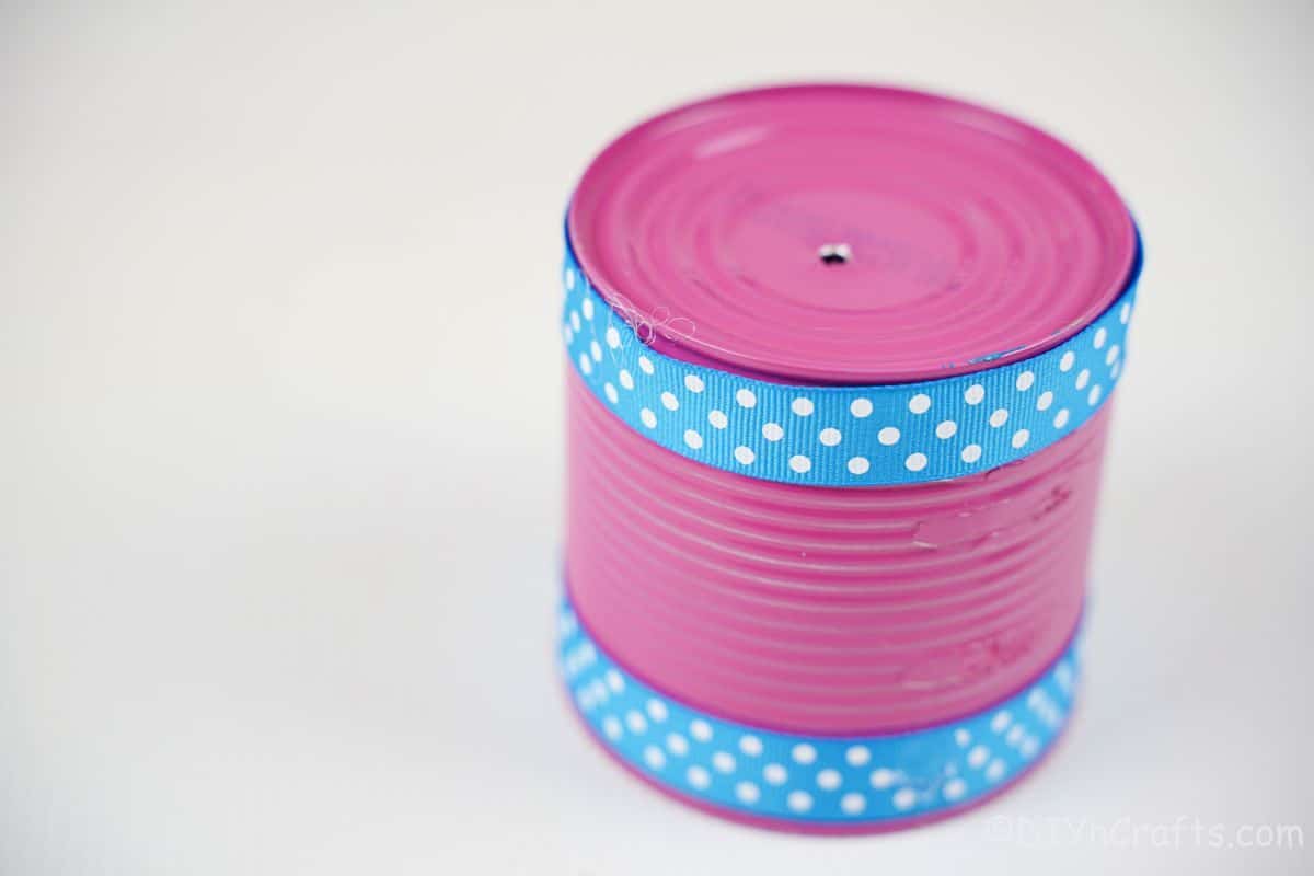 pink tin can with blue polka dot ribbon