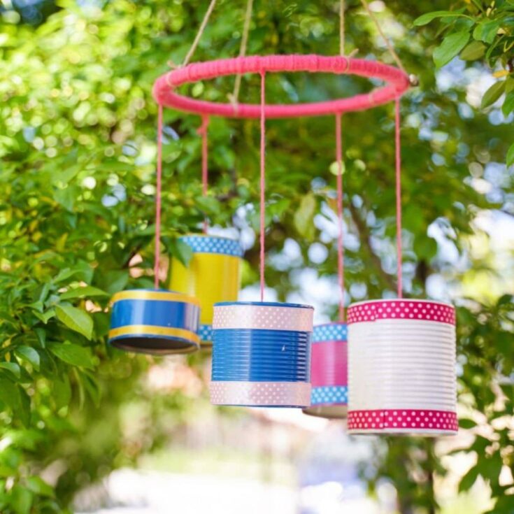 tin can wind chime hanging in tree