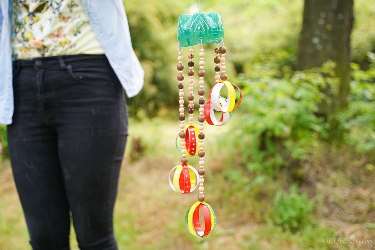 woman holding wind chime outside