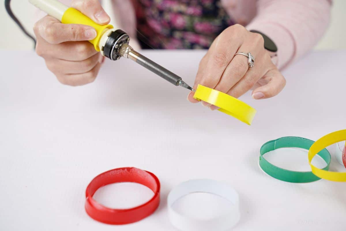 soldering iron adding hole in yellow plastic ring