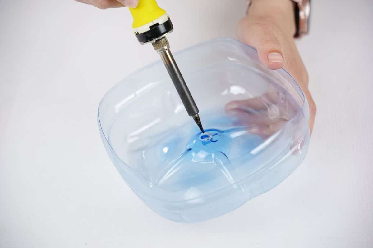 soldering iron being used on center of plastic