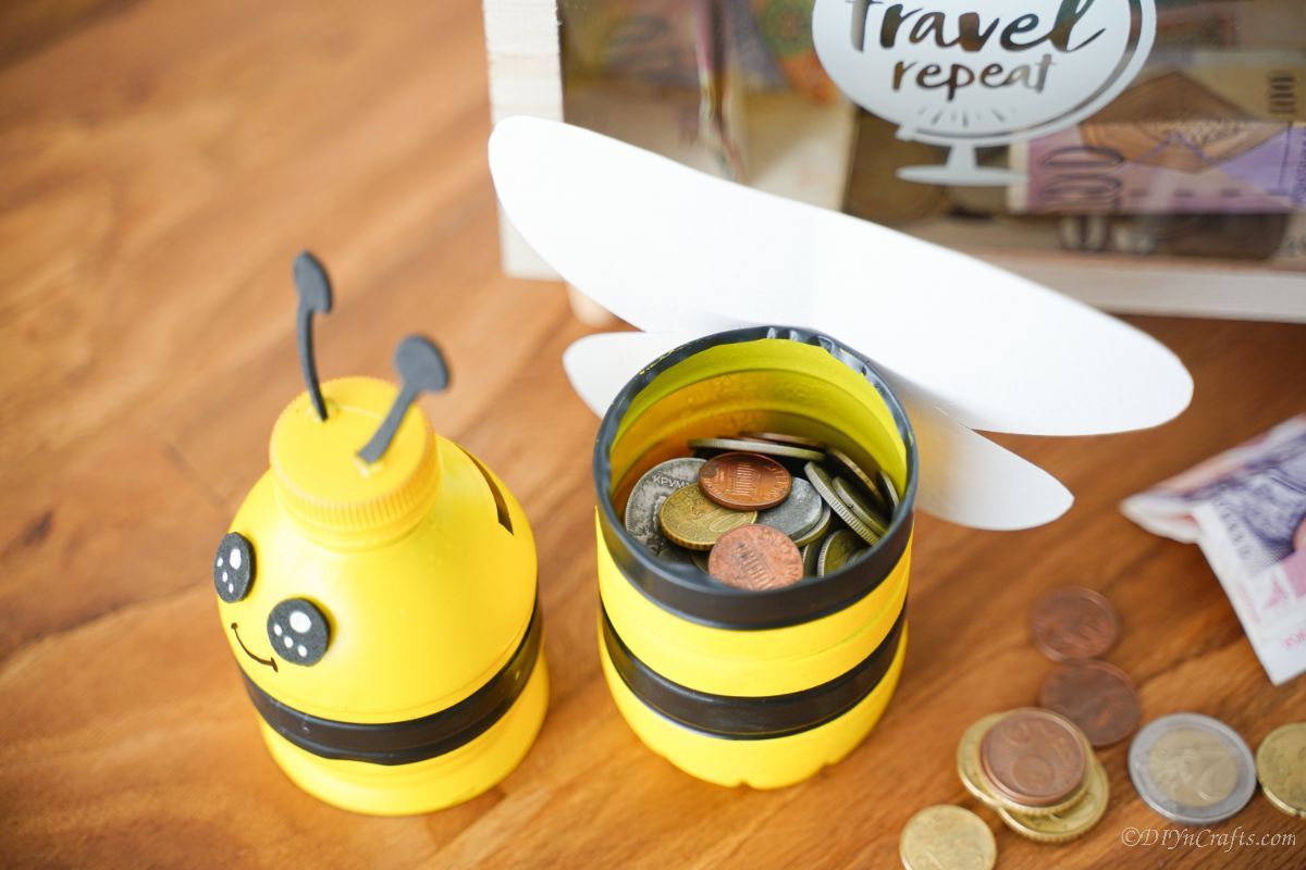 bumblebee piggy bank open on table by coins
